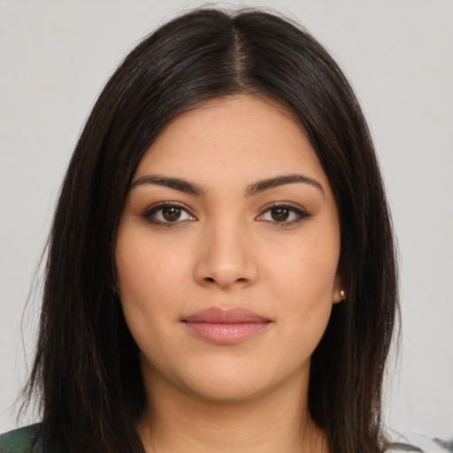 Joyful latino young-adult female with long  brown hair and brown eyes