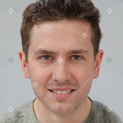 Joyful white adult male with short  brown hair and grey eyes