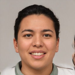 Joyful latino young-adult female with short  brown hair and brown eyes