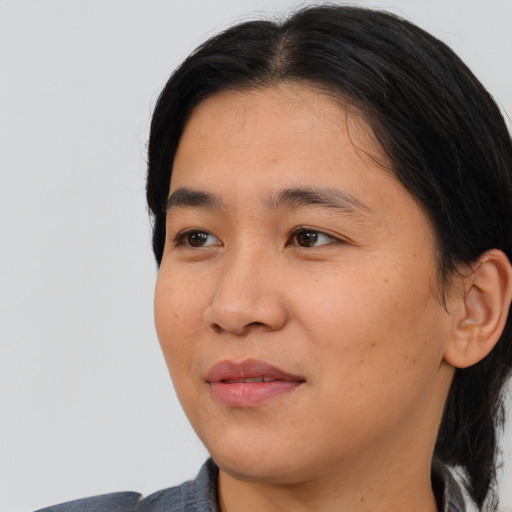 Joyful asian young-adult female with medium  black hair and brown eyes