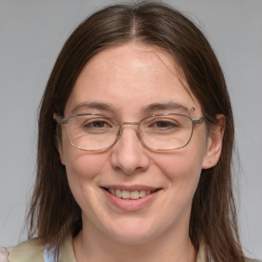 Joyful white adult female with medium  brown hair and grey eyes