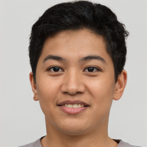Joyful asian young-adult male with short  brown hair and brown eyes