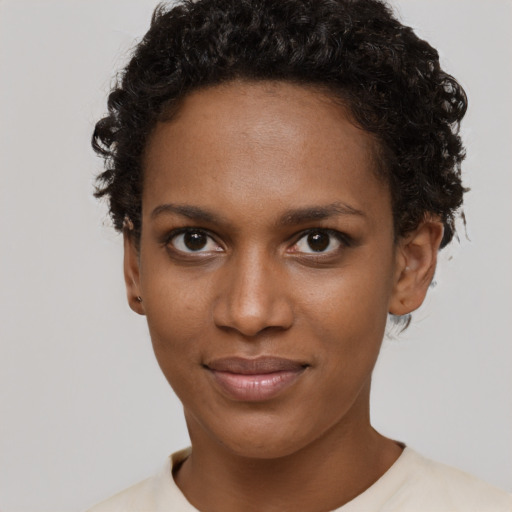 Joyful black young-adult female with short  brown hair and brown eyes