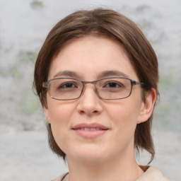 Joyful white adult female with medium  brown hair and grey eyes