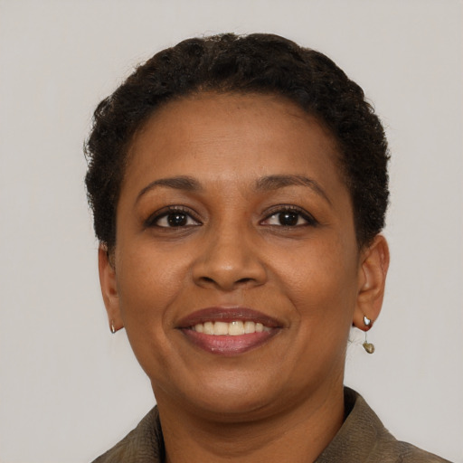 Joyful black adult female with short  brown hair and brown eyes