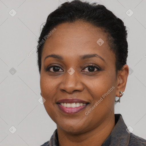 Joyful black adult female with short  black hair and brown eyes