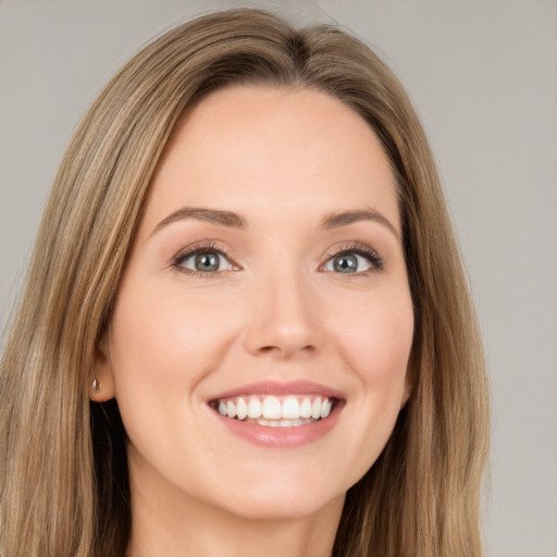 Joyful white young-adult female with long  brown hair and brown eyes