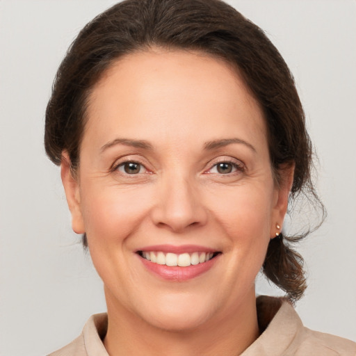 Joyful white adult female with medium  brown hair and brown eyes