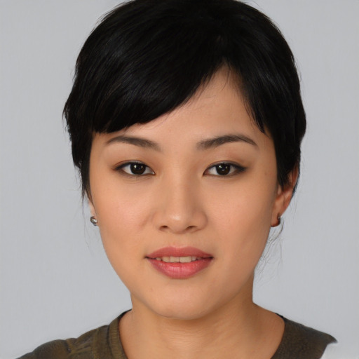 Joyful asian young-adult female with medium  black hair and brown eyes