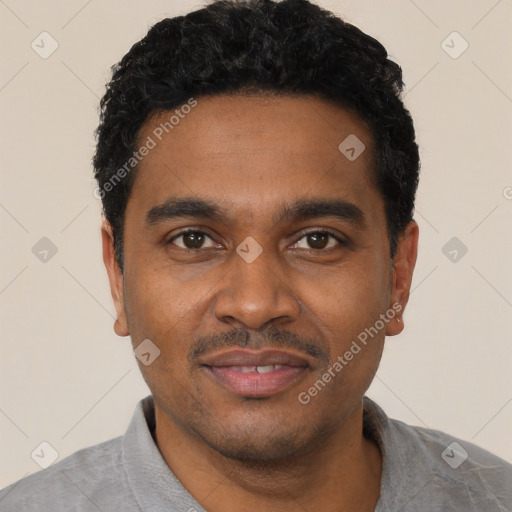 Joyful black young-adult male with short  black hair and brown eyes