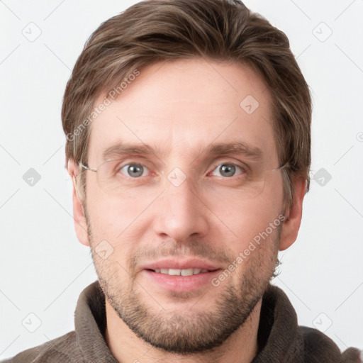 Joyful white young-adult male with short  brown hair and grey eyes