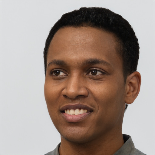 Joyful black young-adult male with short  black hair and brown eyes