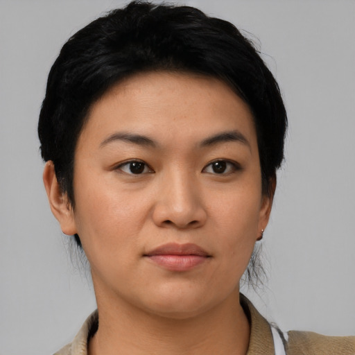 Joyful asian young-adult female with short  black hair and brown eyes