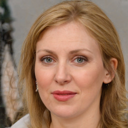 Joyful white adult female with long  brown hair and brown eyes