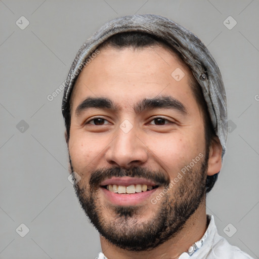 Joyful white young-adult male with short  black hair and brown eyes