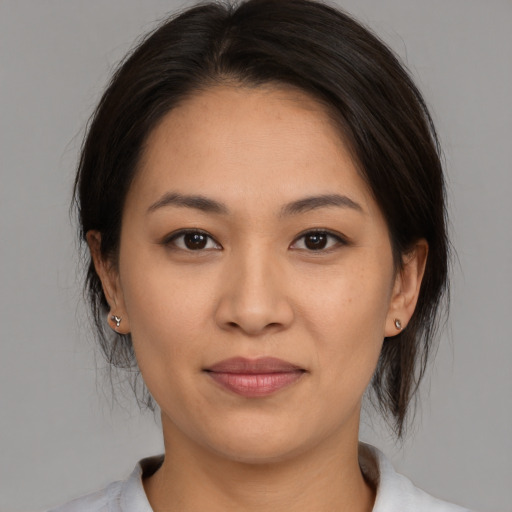 Joyful white young-adult female with medium  brown hair and brown eyes