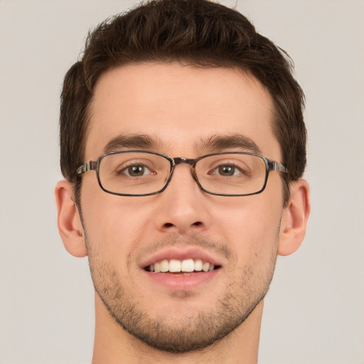 Joyful white young-adult male with short  brown hair and grey eyes