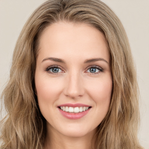 Joyful white young-adult female with long  brown hair and green eyes