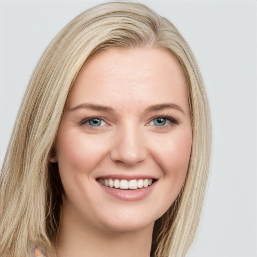 Joyful white young-adult female with long  brown hair and green eyes