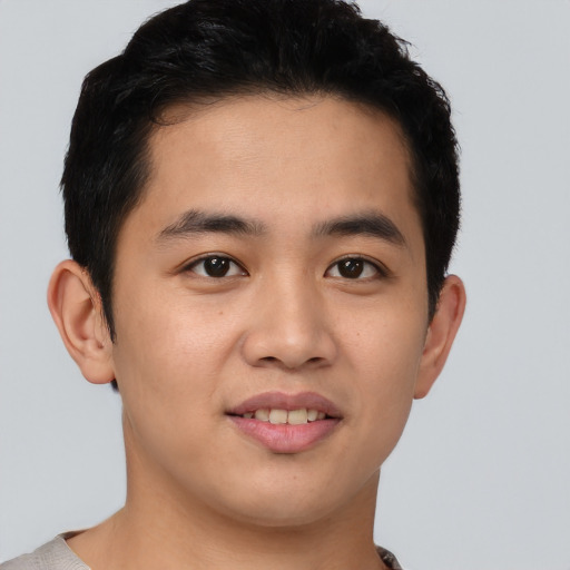 Joyful asian young-adult male with short  brown hair and brown eyes