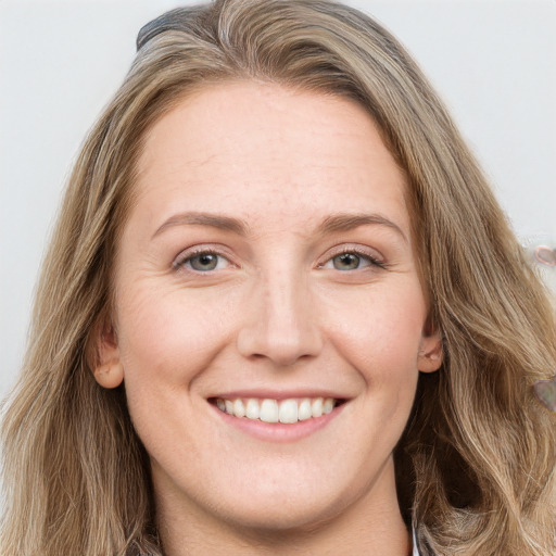 Joyful white young-adult female with long  brown hair and blue eyes