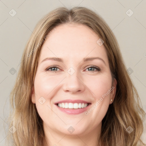 Joyful white young-adult female with long  brown hair and green eyes