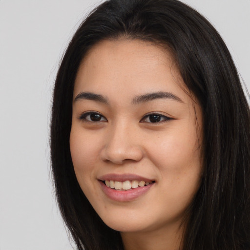 Joyful asian young-adult female with long  brown hair and brown eyes