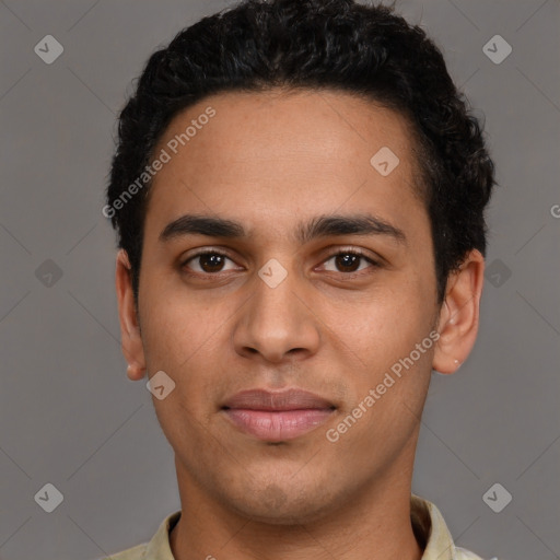 Joyful latino young-adult male with short  brown hair and brown eyes