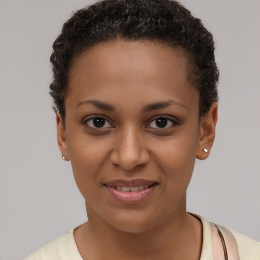 Joyful black young-adult female with short  brown hair and brown eyes
