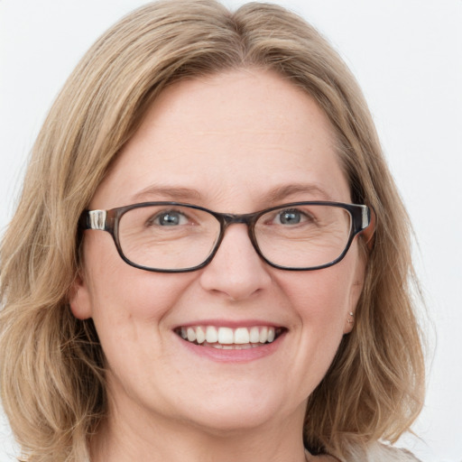 Joyful white adult female with medium  brown hair and blue eyes