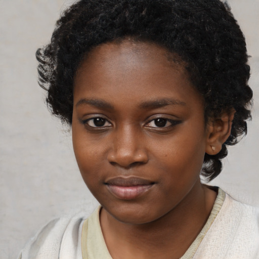 Joyful black child female with short  brown hair and brown eyes