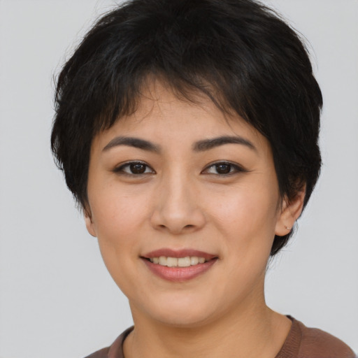 Joyful asian young-adult female with short  brown hair and brown eyes