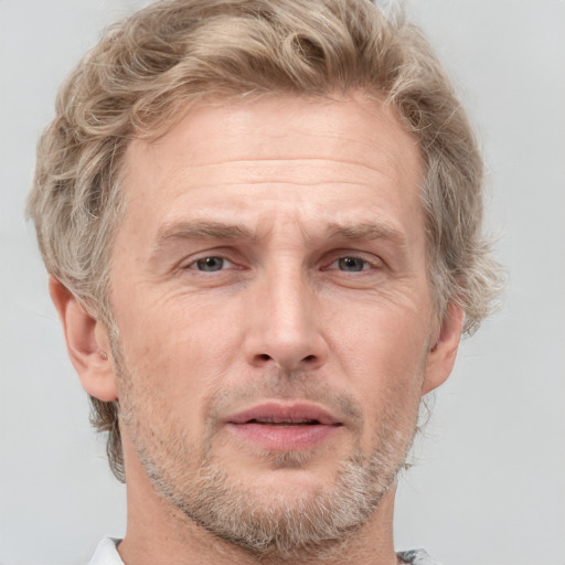 Joyful white adult male with short  brown hair and grey eyes