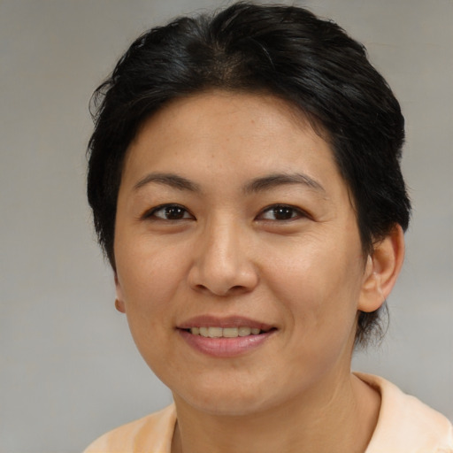 Joyful asian adult female with medium  brown hair and brown eyes