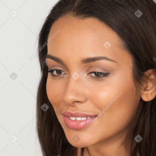 Joyful latino young-adult female with long  brown hair and brown eyes