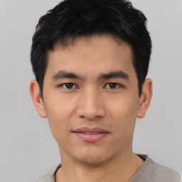 Joyful asian young-adult male with short  black hair and brown eyes