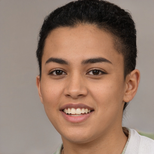 Joyful latino young-adult female with short  brown hair and brown eyes