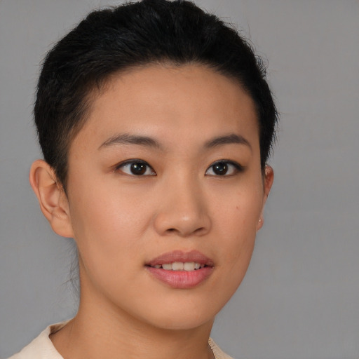 Joyful asian young-adult female with short  brown hair and brown eyes