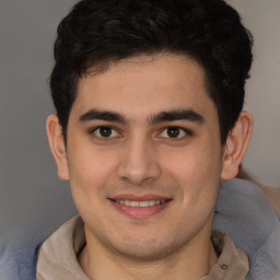 Joyful latino young-adult male with short  brown hair and brown eyes