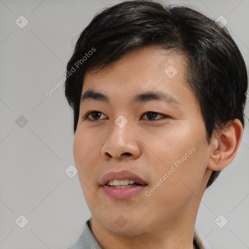 Joyful asian young-adult male with short  brown hair and brown eyes