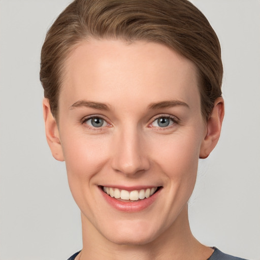 Joyful white young-adult female with short  brown hair and grey eyes