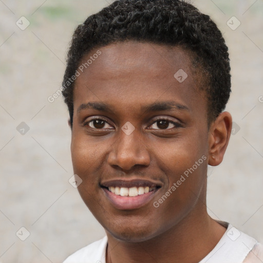 Joyful black young-adult male with short  brown hair and brown eyes