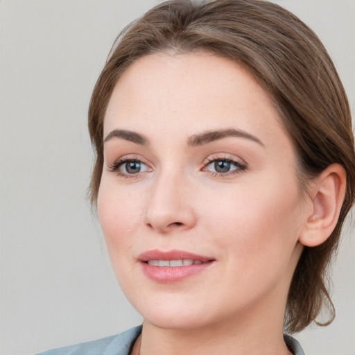 Joyful white young-adult female with medium  brown hair and blue eyes