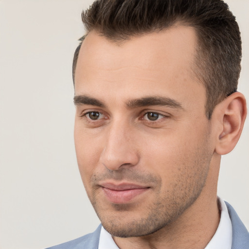 Joyful white young-adult male with short  brown hair and brown eyes