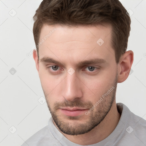 Neutral white young-adult male with short  brown hair and grey eyes