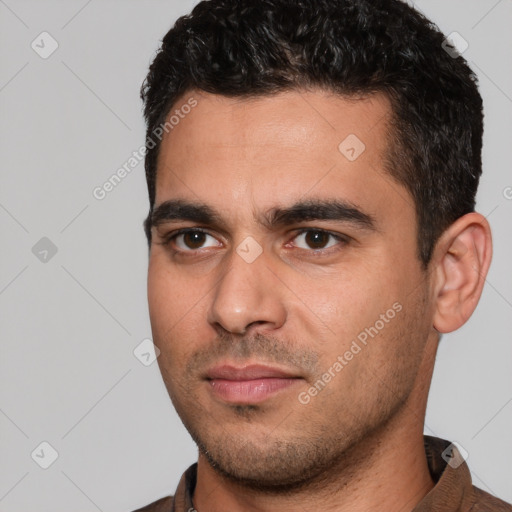 Joyful white young-adult male with short  black hair and brown eyes