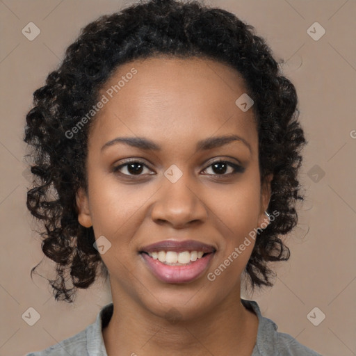 Joyful black young-adult female with long  black hair and brown eyes