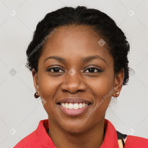 Joyful black young-adult female with short  black hair and brown eyes