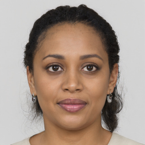 Joyful black young-adult female with medium  black hair and brown eyes