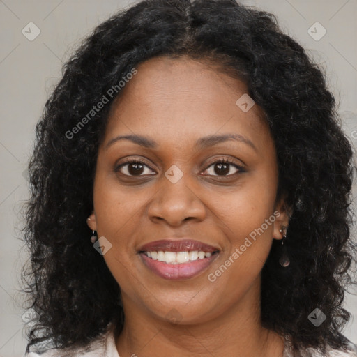 Joyful black young-adult female with long  brown hair and brown eyes